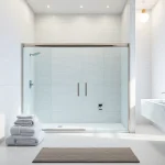 Gorgeous shower sliding doors framed by upscale tiles, reflecting elegance and modern design.