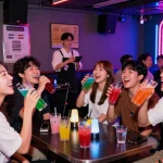 Experience lively 제주도유흥 nightlife with friends singing at a vibrant karaoke bar filled with colorful drinks and neon lights.