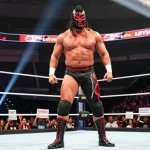 Abyss wrestler in the spotlight, showcasing strength and intensity in the wrestling arena.